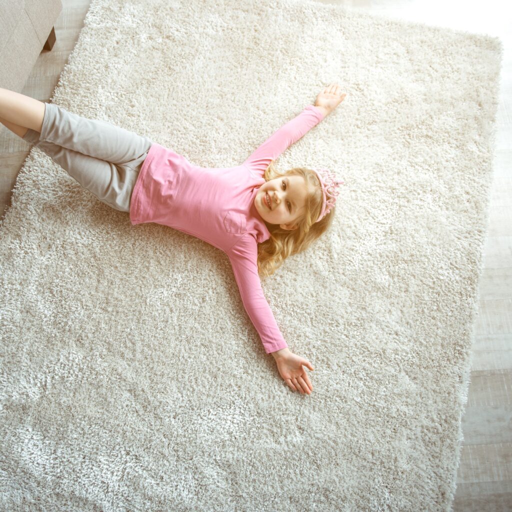 Cute girl laying on rug | Carpet Selections